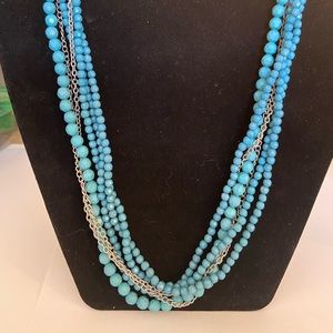 Turquoise colored beads and silver tone multi strand necklace